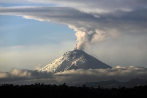 A large plume of ash and steam rises from the Cotopaxi volcano as seen from Quito, Ecuador, Thursday, Oct. 8, 2015. The Geophysics Institute said during the first week of October the Cotopaxi has shown an increase in emission of ash and temperature, and a noted glow in the crater. (AP Photo/Dolores Ochoa)