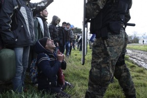 A man kneels before a Macedonian police officer in an effort to cross the border, near the northern Greek village of Idomeni, Thursday, Nov. 26, 2015. Scores of migrants stranded at Greece’s northern border have clashed with police while trying to force their way into Macedonia. Macedonia toughened rules for migrant crossings earlier this month, restricting access to citizens from countries typically granted asylum in Europe, including Syria and Afghanistan. (AP Photo/Giannis Papanikos)