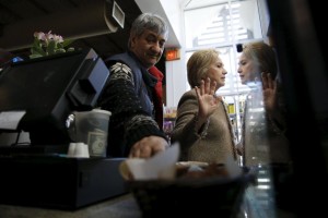 U.S. Democratic presidential candidate Hillary Clinton politely declines to eat more cake samples, after having tried the coconut pound cake and purchasing items to go from Saffron Cafe and Bakery owner Ali Rahnamoon as she greets people at his cafe in Charleston, South Carolina February 26, 2016. REUTERS/Jonathan Ernst      TPX IMAGES OF THE DAY
