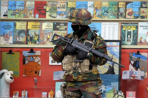 A Belgian soldier stands guard in front of a shop selling Tintin comic books in central Brussels, Belgium, March 24, 2016.    REUTERS/Vincent Kessler       TPX IMAGES OF THE DAY
